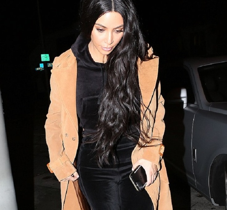 Girls night! Kim Kardashian rocks all black outfit and beige trench coat as she takes Kourtney to dinner in LA