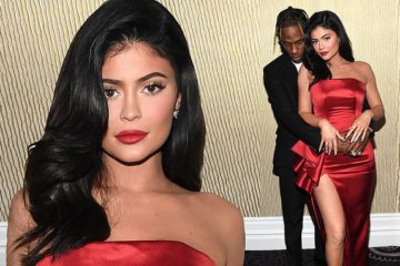 Kylie Jenner is a siren in scarlet as she and Travis Scott embrace backstage at Clive Davis bash
